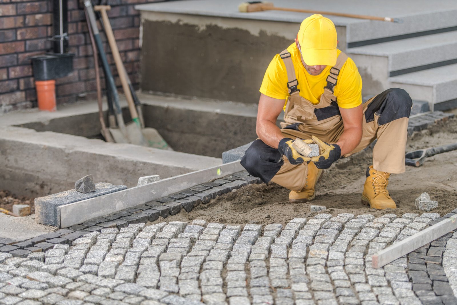 contractor installing pavers